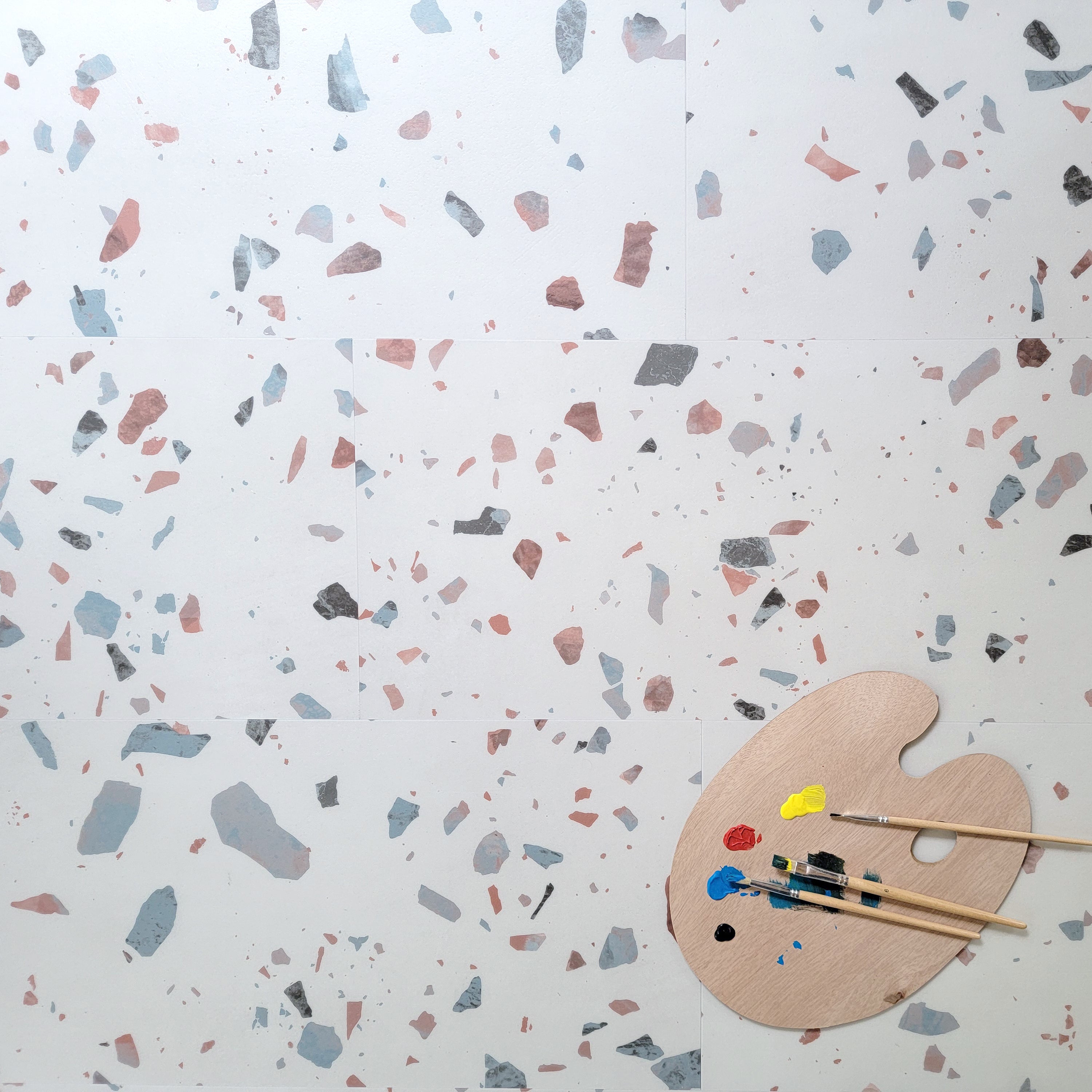 Earl Grey terrazzo vinyl tiles with artists pallet with colors and brushes on top