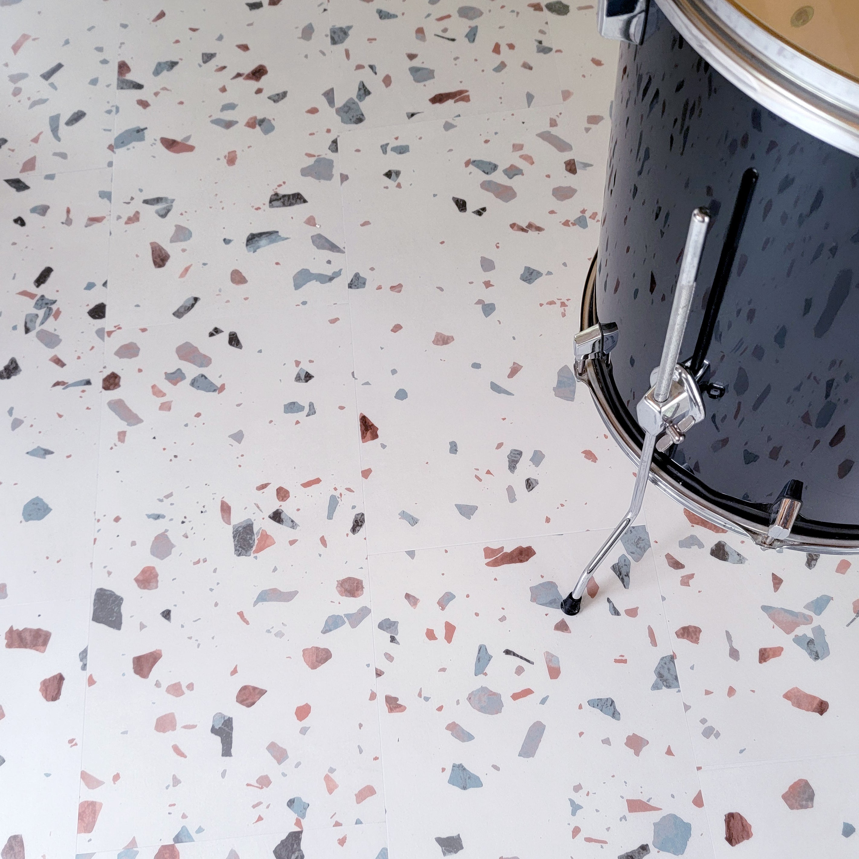 Earl Grey terrazzo vinyl tiles with black floor drum