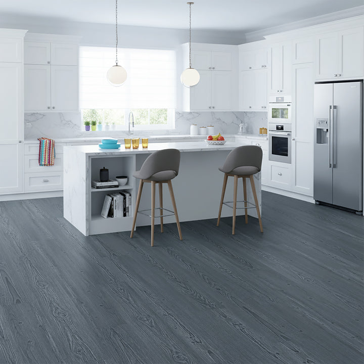 Modern kitchen with gray Allure LVP flooring, white cabinets, and stainless steel appliances.