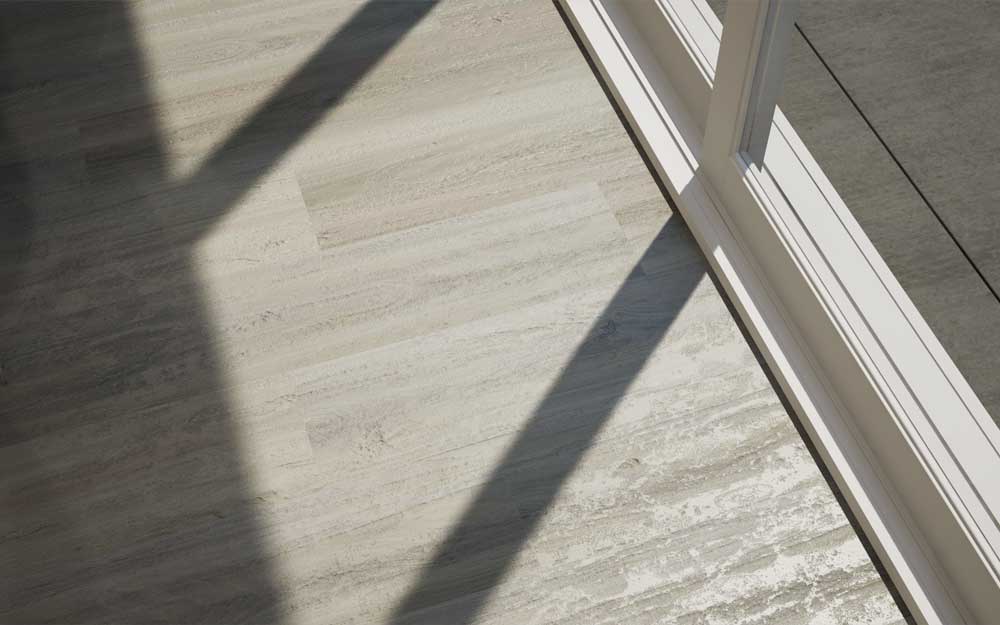 Allure Luxury vinyl plank flooring installed next to a sliding glass door with sunlight casting shadows.