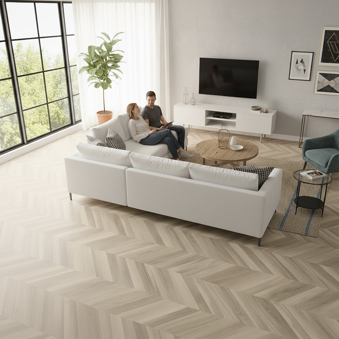Living room with Allure chevron flooring, a white sofa, coffee table, and TV stand.