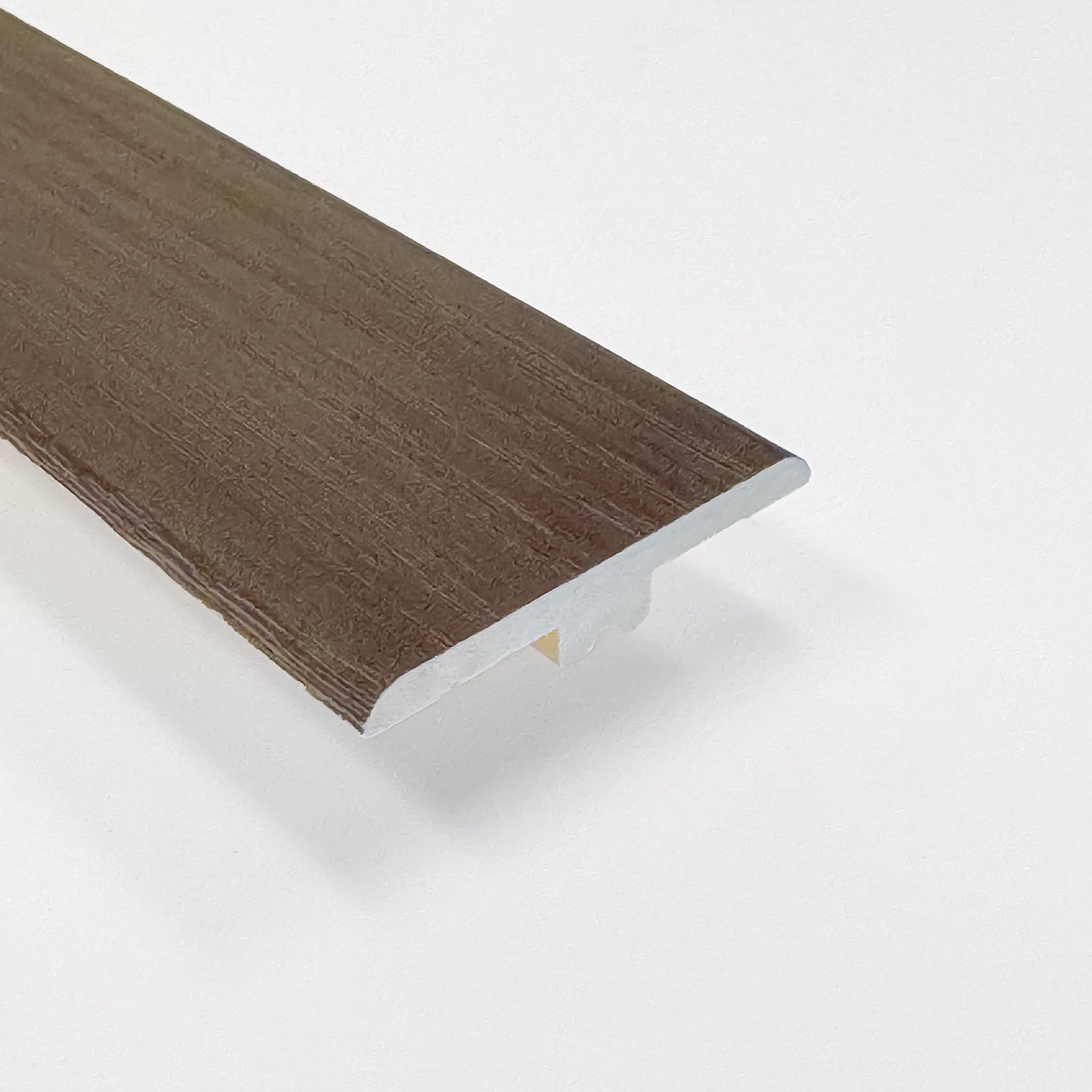 Brown wood look vinyl transition strip on a white background