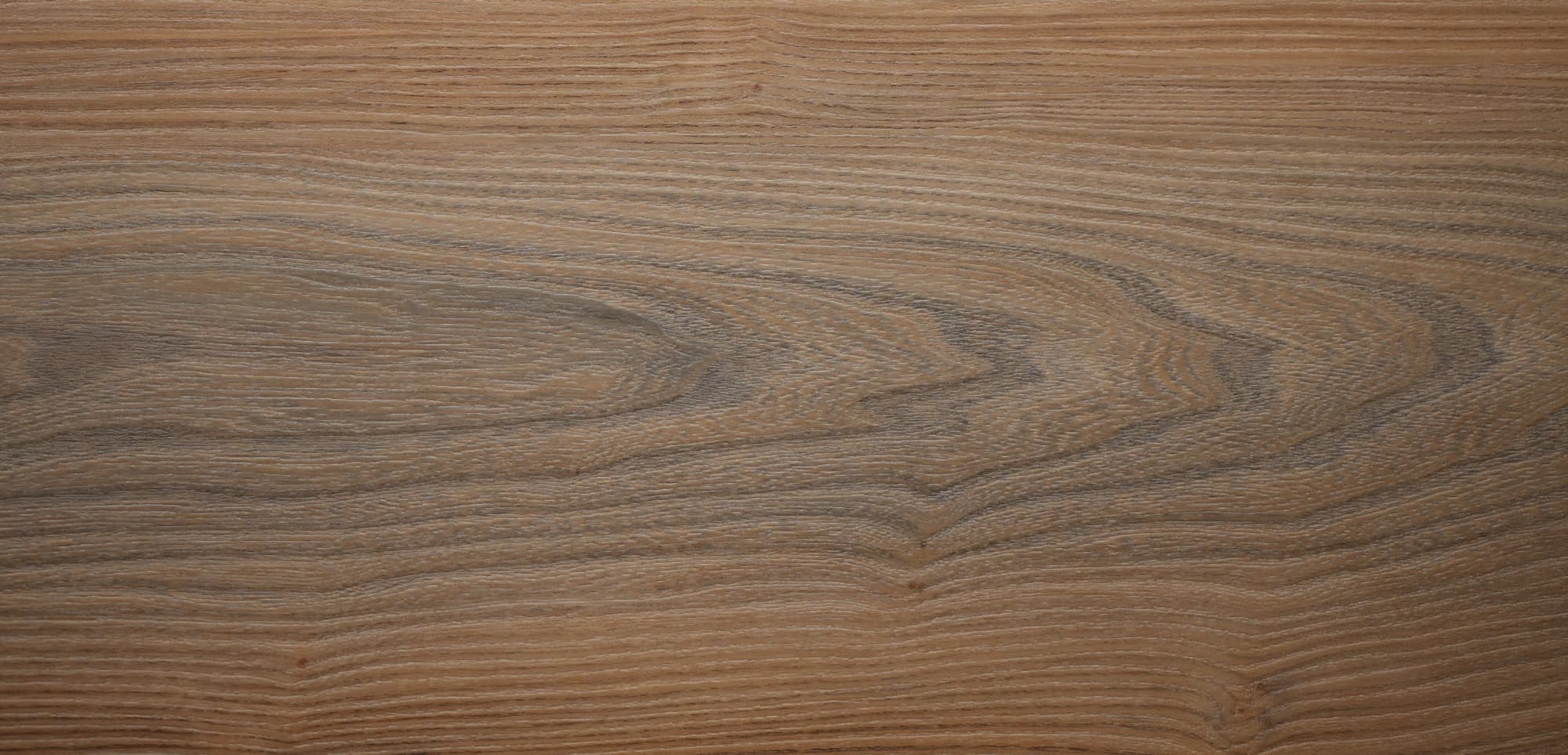 Close-up of a vinyl flooring with wooden surface with visible grain and texture in cool light