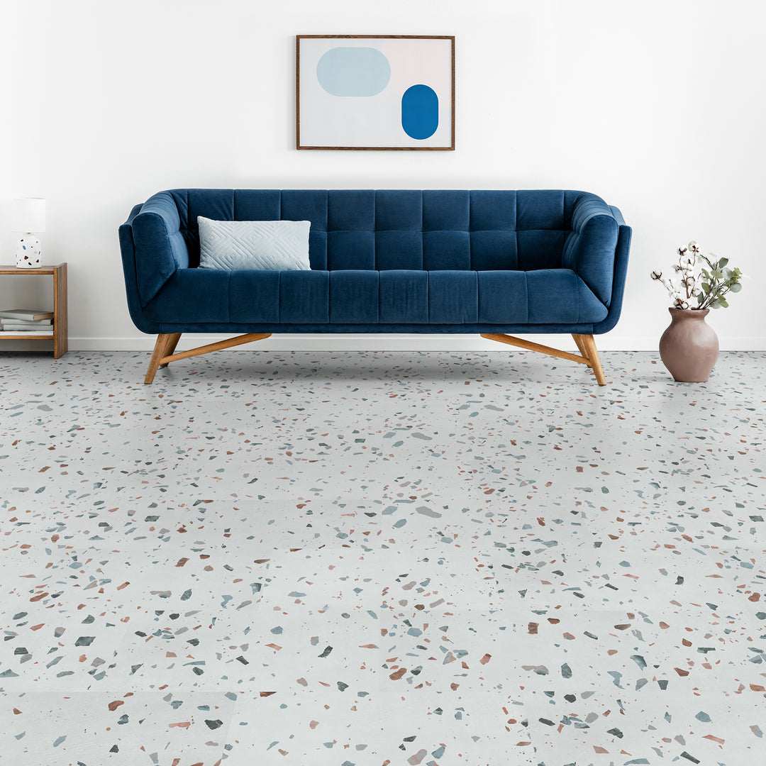 Ultima Earl Grey Terrazzo LVT installed with mid-century modern blue couch and wall art