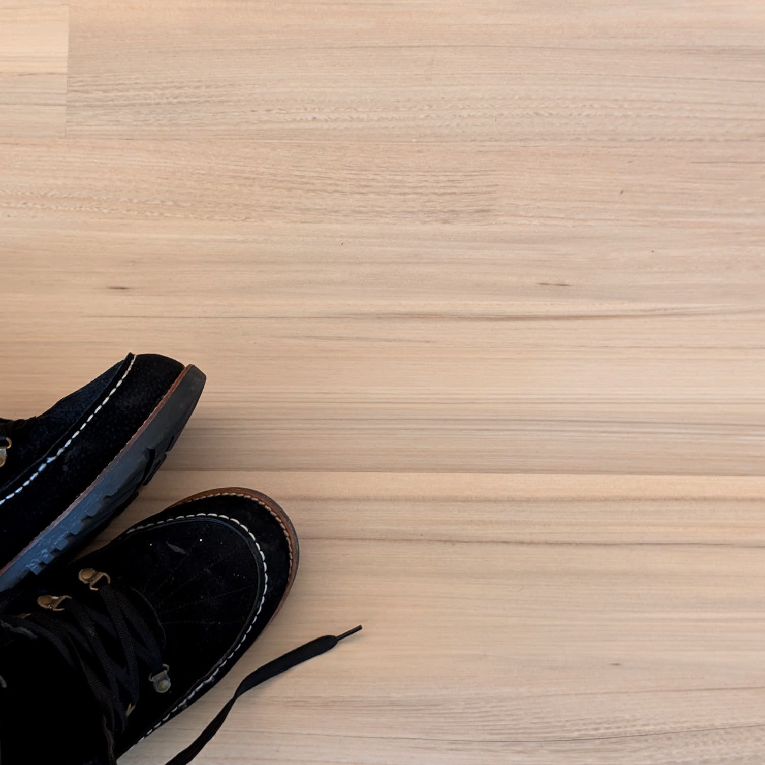 winter boots sitting on top of green tea tulip vinyl flooring