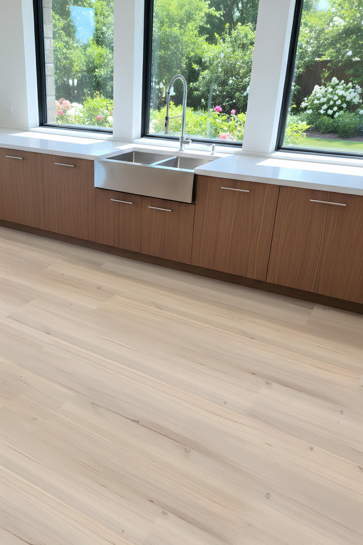 Modern kitchen with Allure LVP flooring, wooden cabinets and a stainless steel sink.