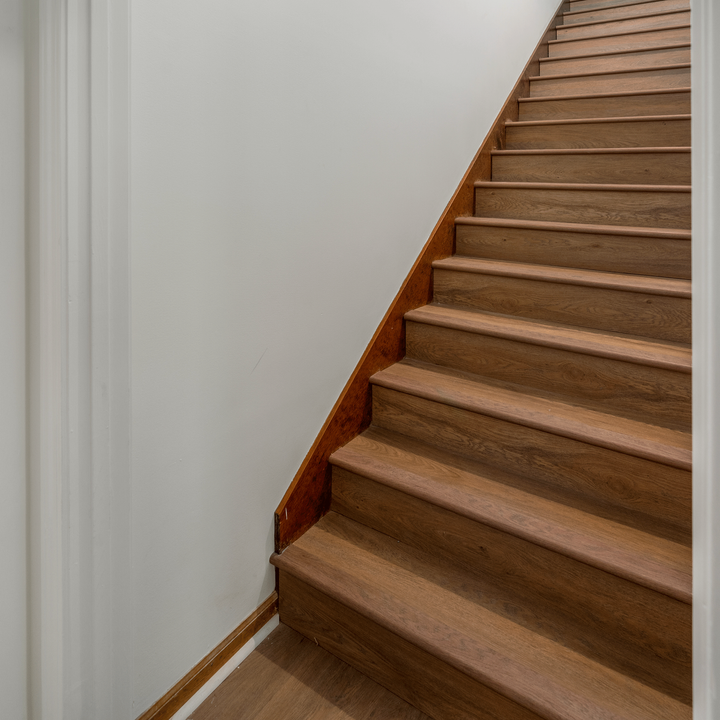 Allure Gingermisu Maple ISOCORE vinyl flooring installed in on stairs with matching looks like our overlap stairnose