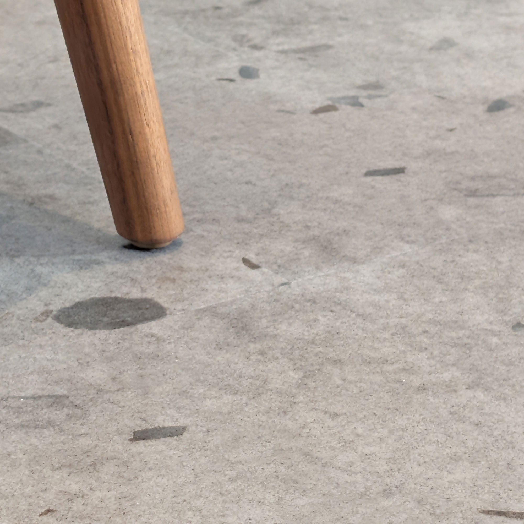 Close up of Galaway Grey terrazzo LVT with chair leg