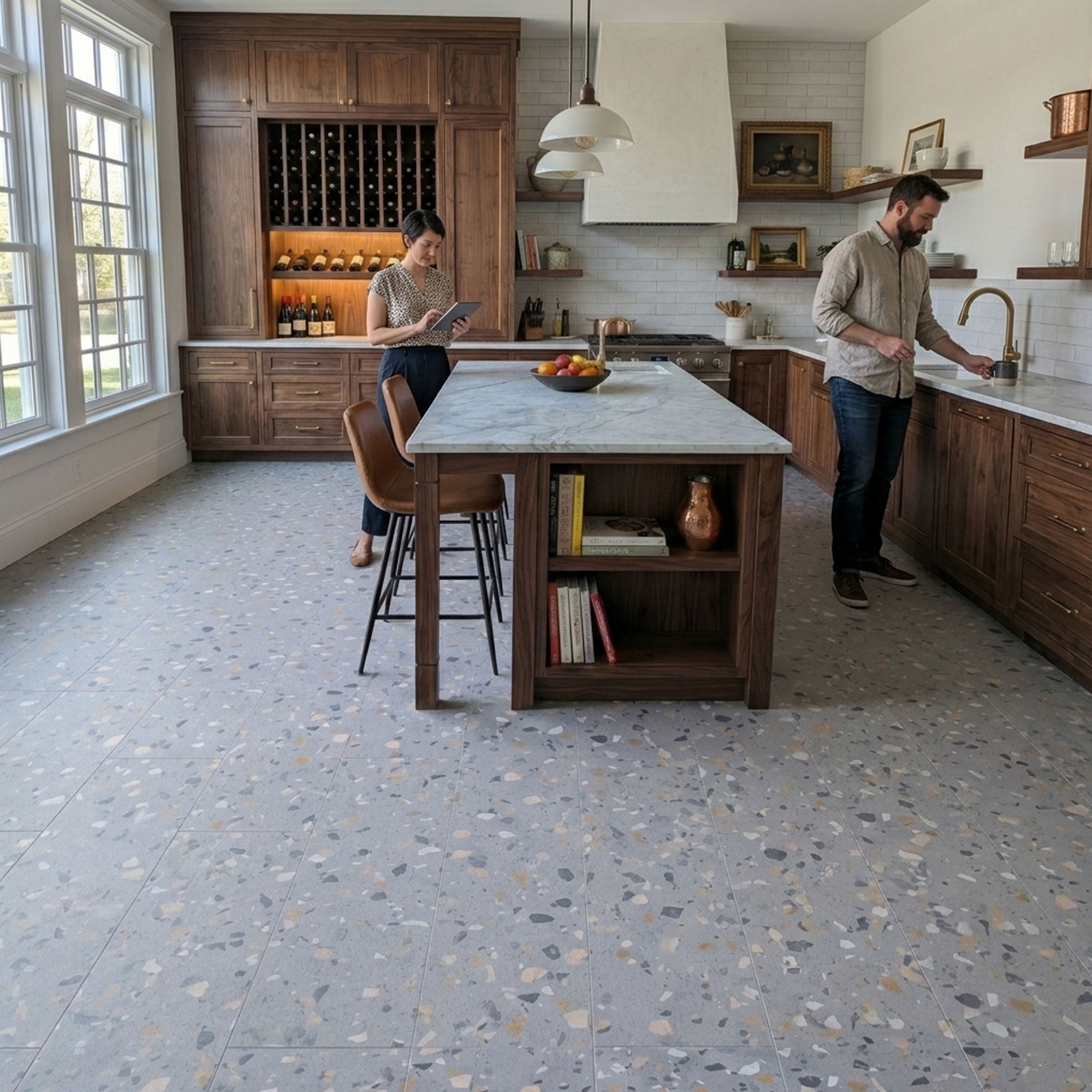 Modern kitchen with a couple standing near an island, featuring wooden cabinets and a peach pebble terrazzo