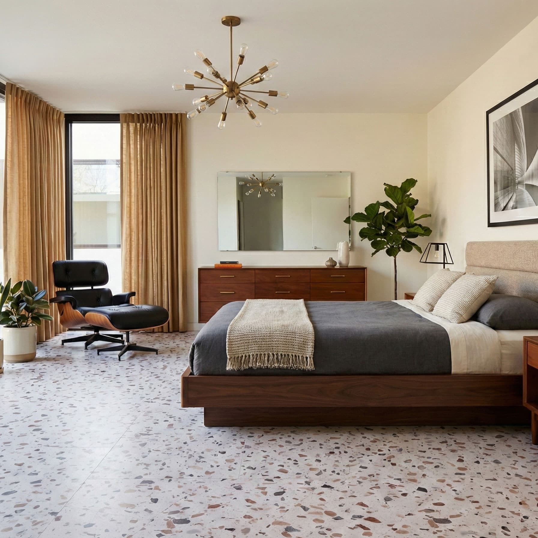 Modern bedroom with a bed, chair, decorative elements, and Allure terrazzo tile flooring.