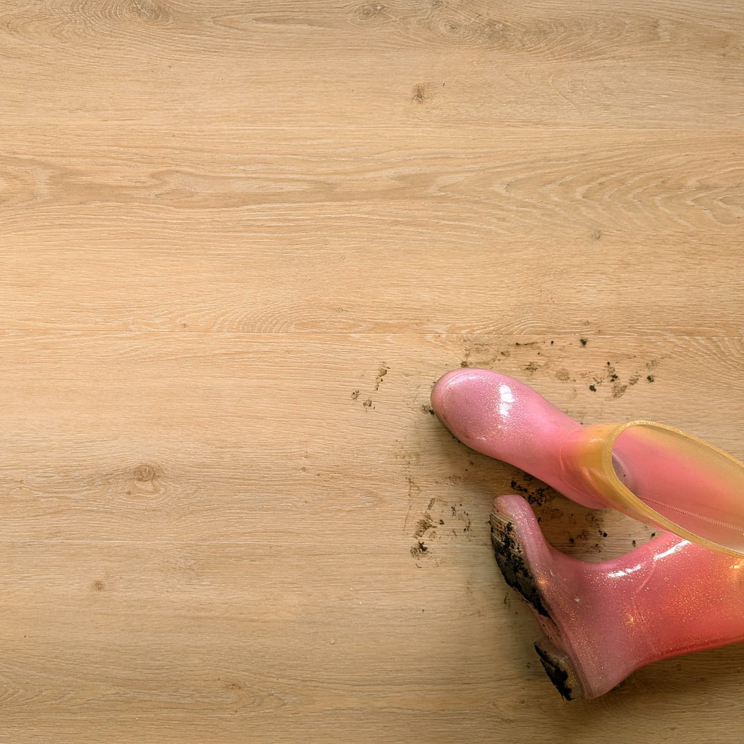 Allure Honey Butter Oak 22mil Luxury Vinyl Plank with a little girls dirty muddy boots