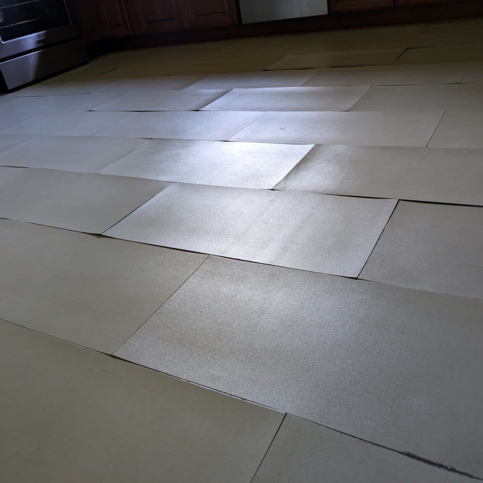 Peel and stick flooring lifting up on a kitchen