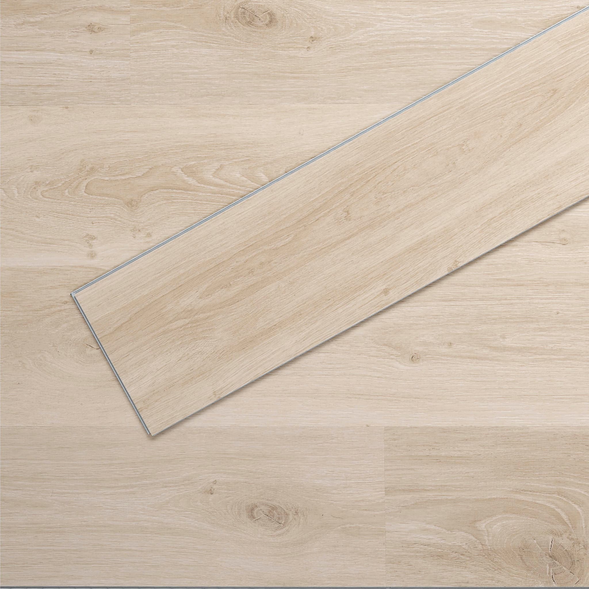 Allure luxury vinyl flooring in Soft Oak Sand installed floor view from above with close up of single plank laying on top showing grooves and edges