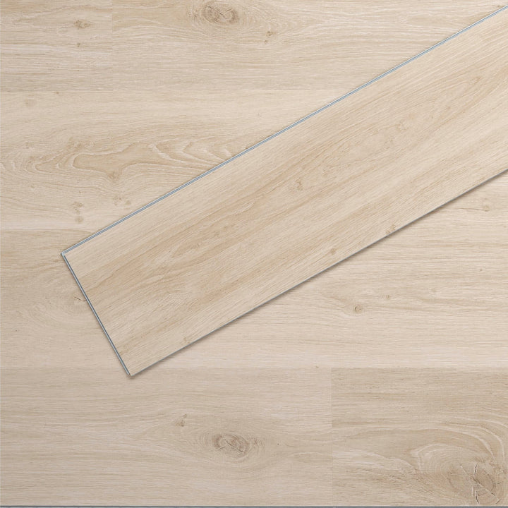 Allure luxury vinyl flooring in Soft Oak Sand installed floor view from above with close up of single plank laying on top showing grooves and edges