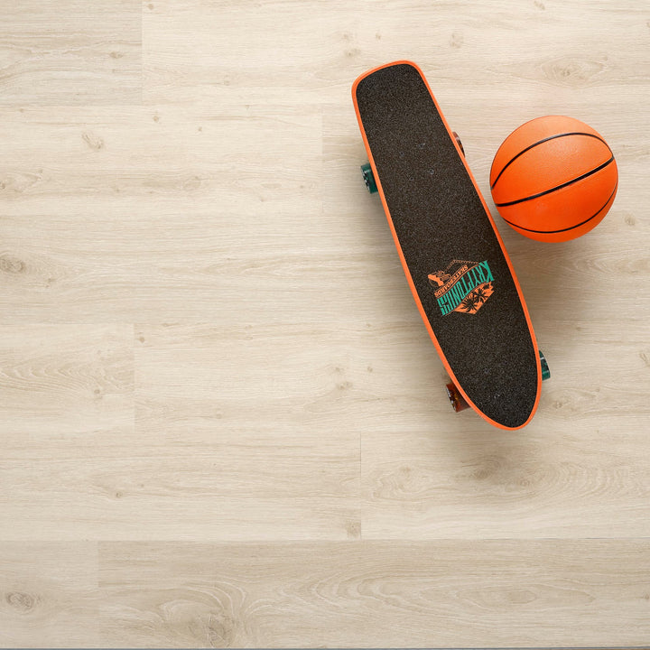 Allure luxury vinyl plank flooring in Soft Oak Sand installed floor view from above with skateboard and basketball