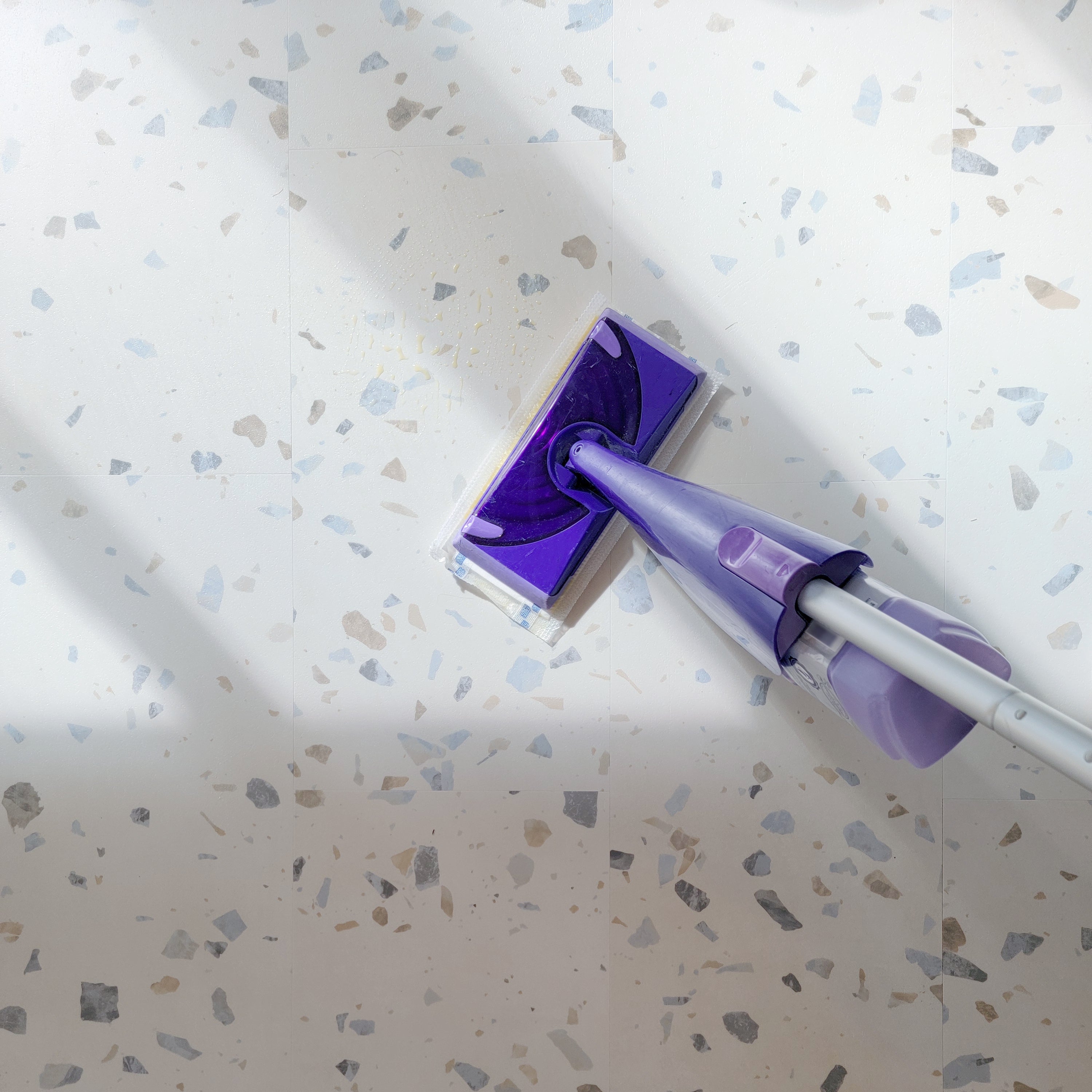 Allure terrazzo vinyl flooring being wet mopped