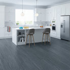 Modern kitchen with gray Allure LVP flooring, white cabinets, and stainless steel appliances.