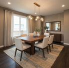 Dining room with wooden table, white chairs, decorative elements, and Allure walnut LVP flooring.