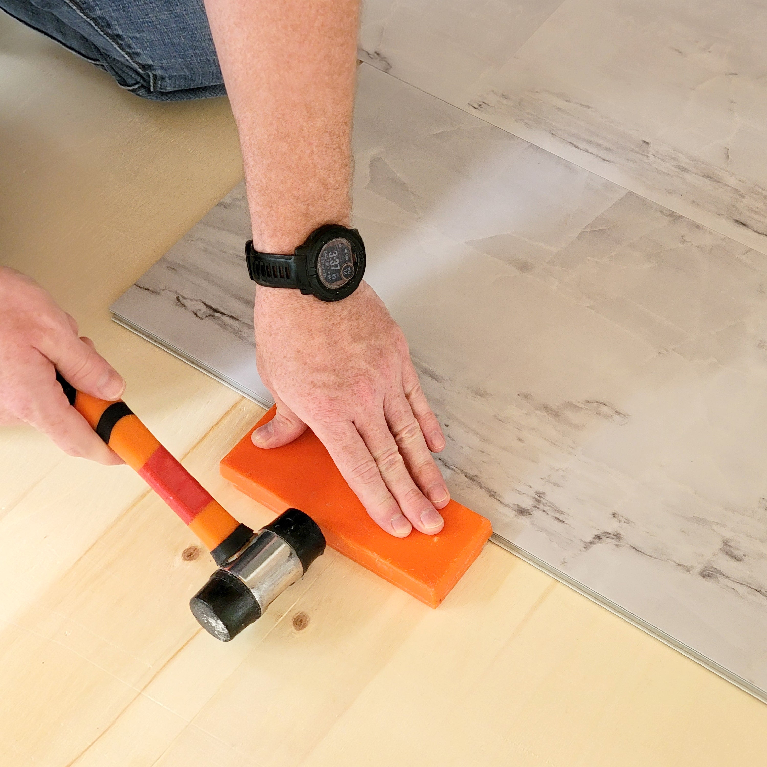 Installing Allure luxury vinyl tile with mallet and tapping block