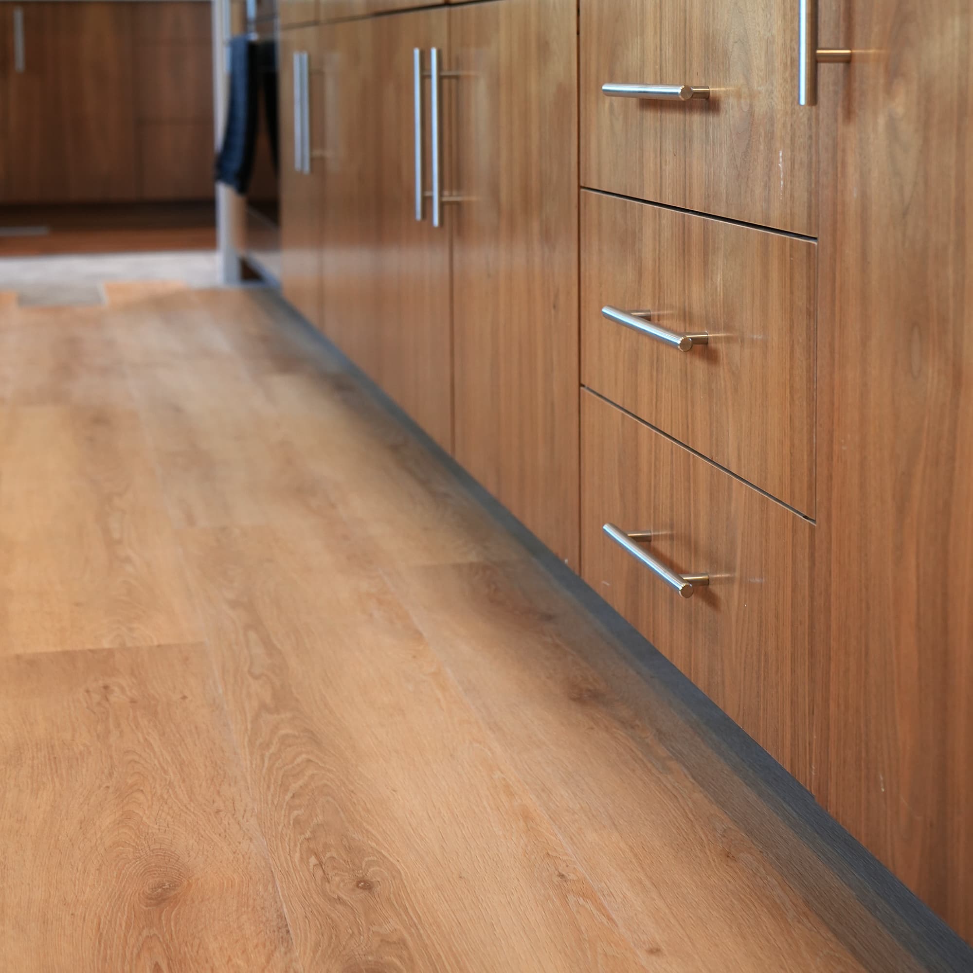 Allure Honey Butter Oak LVP in galley kitchen with tan cabinets