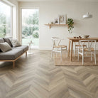 Scandi design livingroom with light colored chevron vinyl flooring by Allure