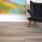 Allure luxury vinyl plank with painting on white wall and charcoal mid-century modern chair