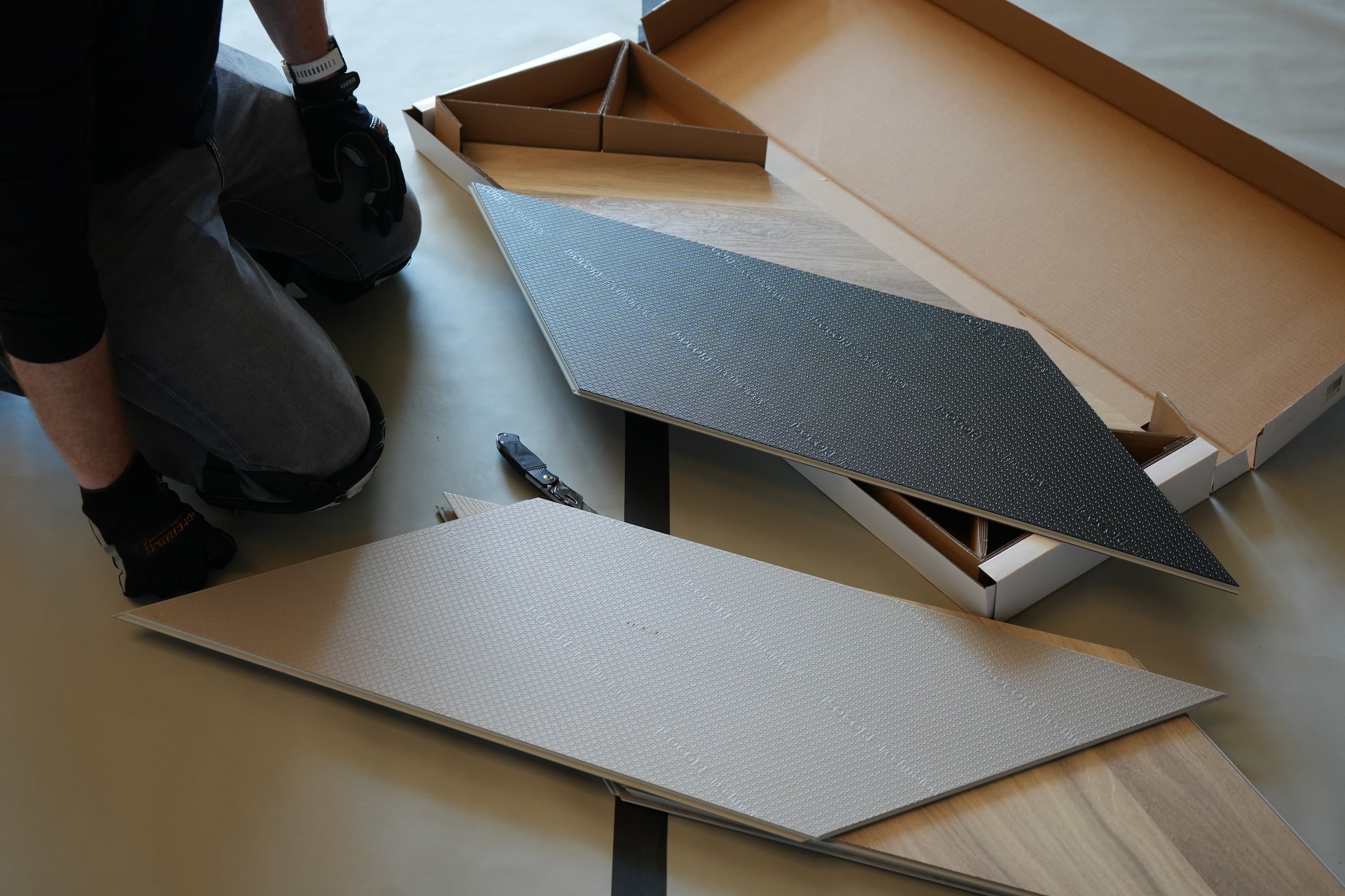 Man unboxing chevron flooring