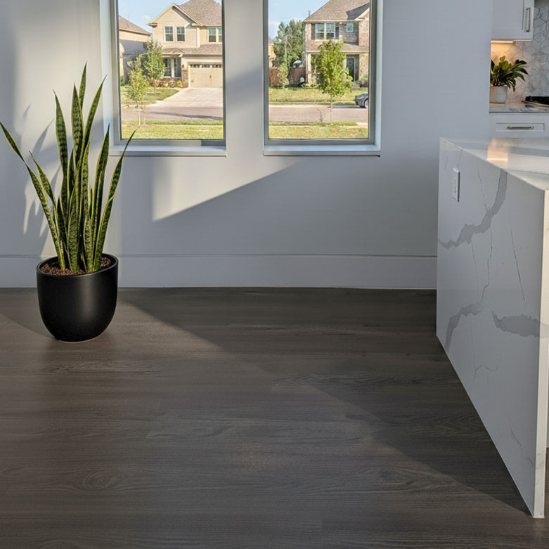 Modern interior with Allure LVP flooring, a plant, kitchen counter, and view of suburban houses through large windows.