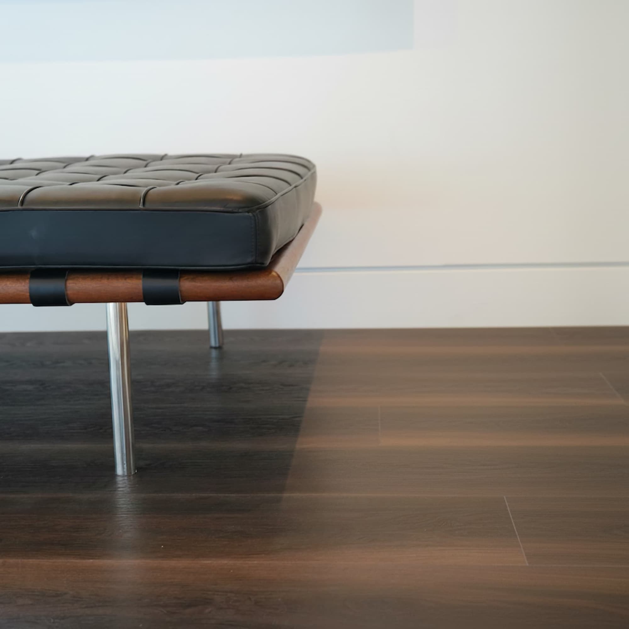 Allure Buckeye Black Walnut flooring planks with a MCM chair