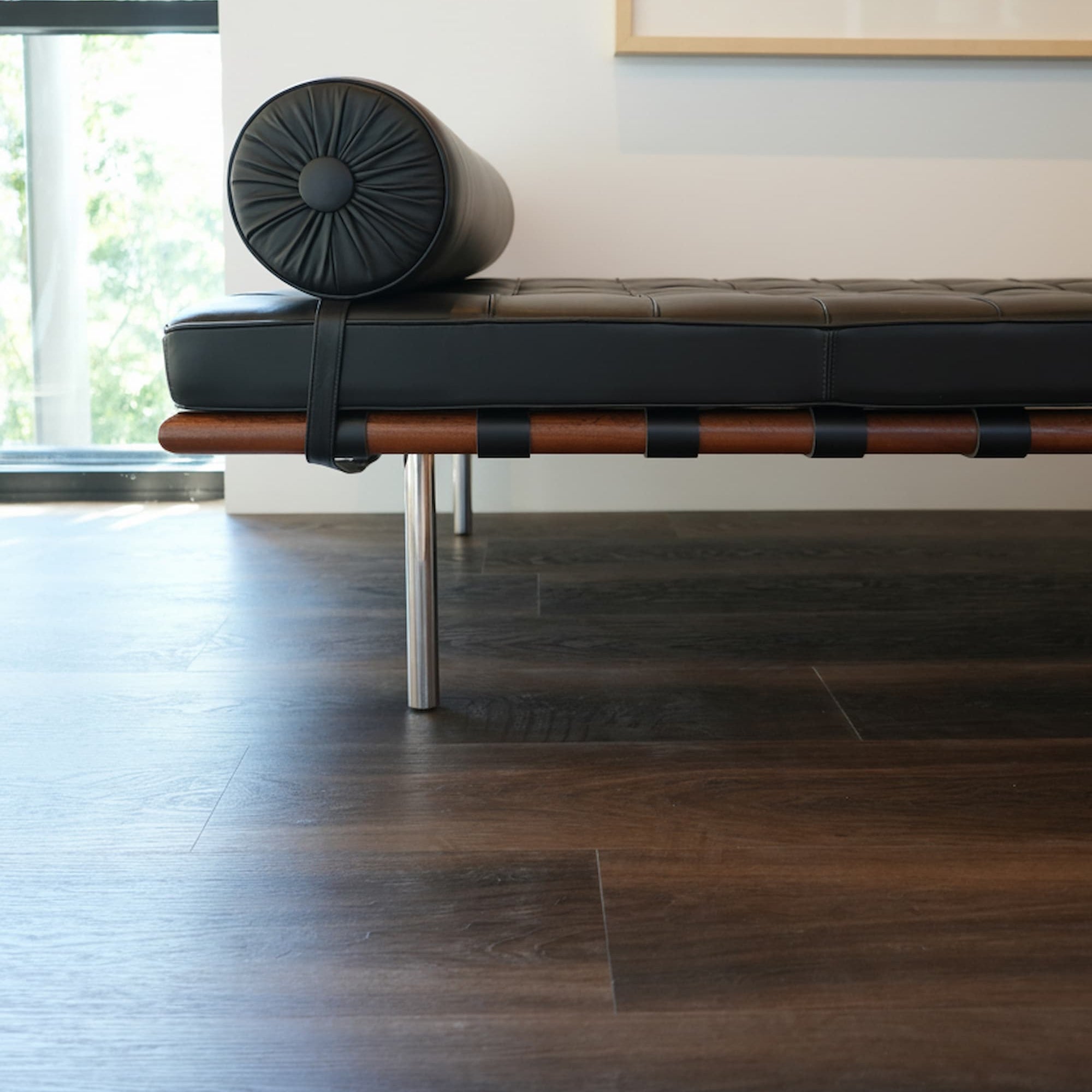 Allure buckeye black walnut lvp with modern chair and black and white photo on a white wall