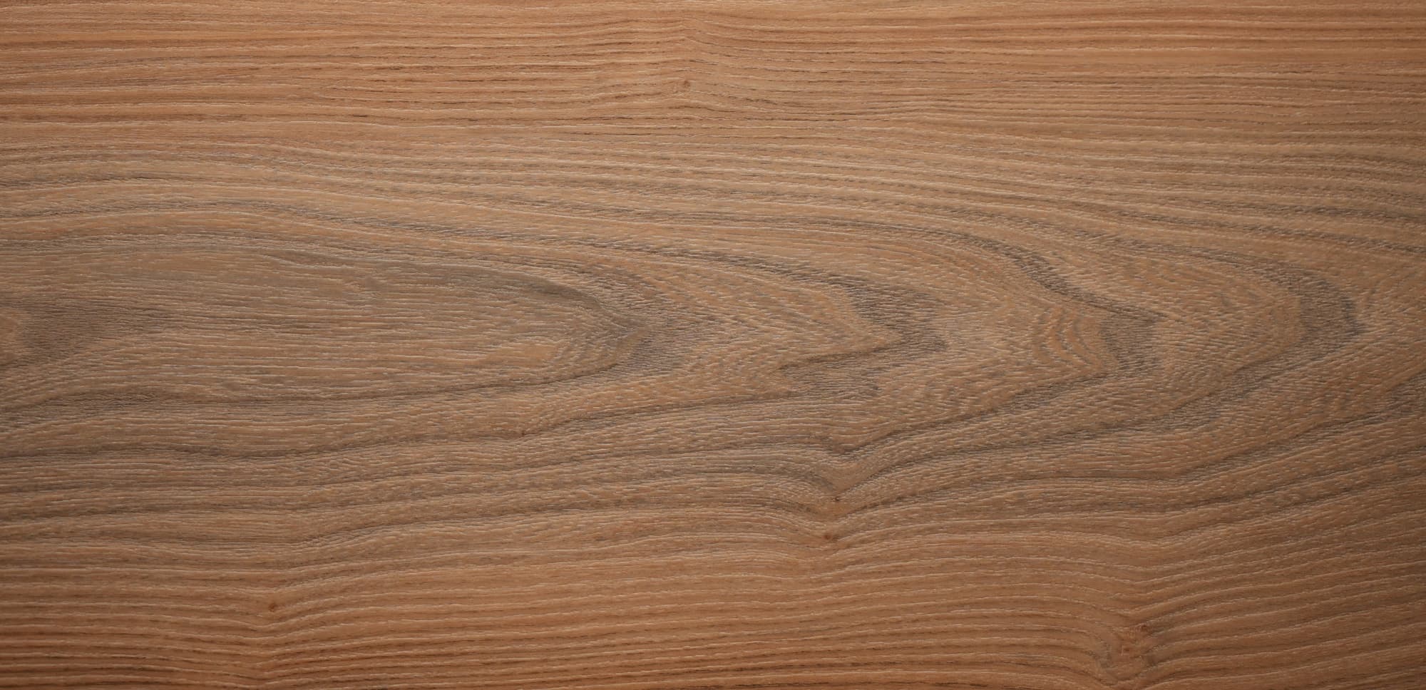 Close-up of a vinyl flooring with wood texture with visible grain and texture