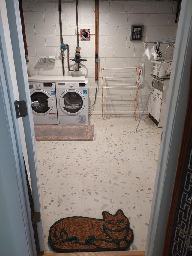 Laundry room with washing machines, dryer, and a doormat with a cat design showcasing perfect parfait terrazzo