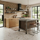Modern kitchen with wooden cabinets, island, and brick wall.