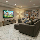 Family watching a cartoon on a large TV in a modern living room.
