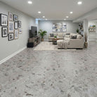 Allure Galaway Grey terrazzo LVT with cork backing in a modern basement with neutral furniture