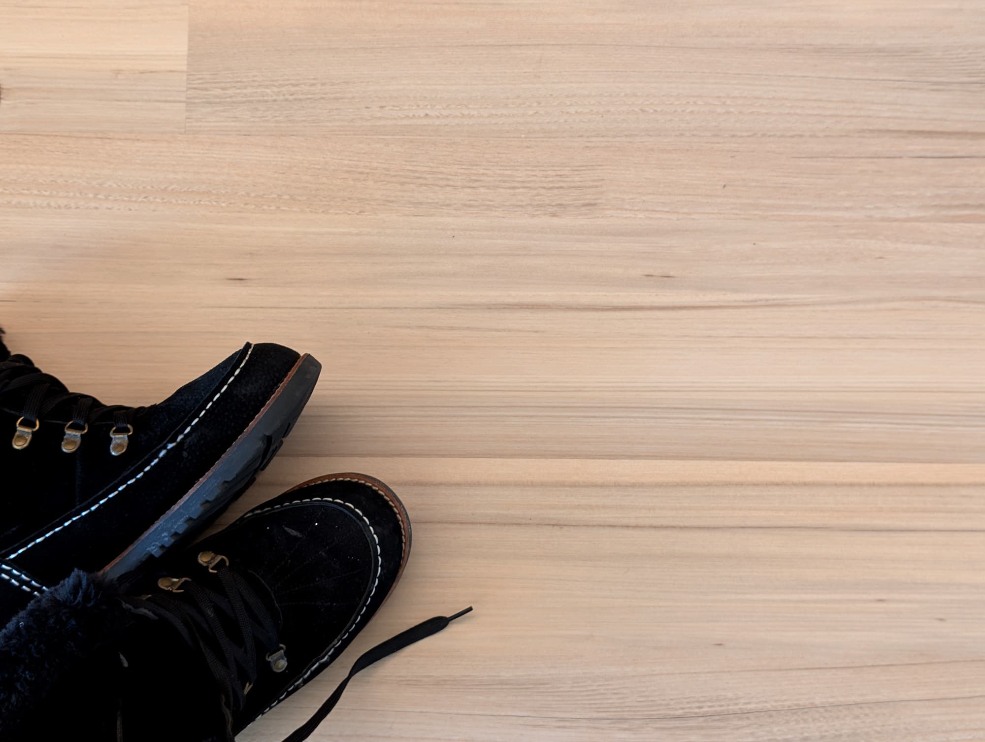 winter boots sitting on top of green tea tulip vinyl flooring
