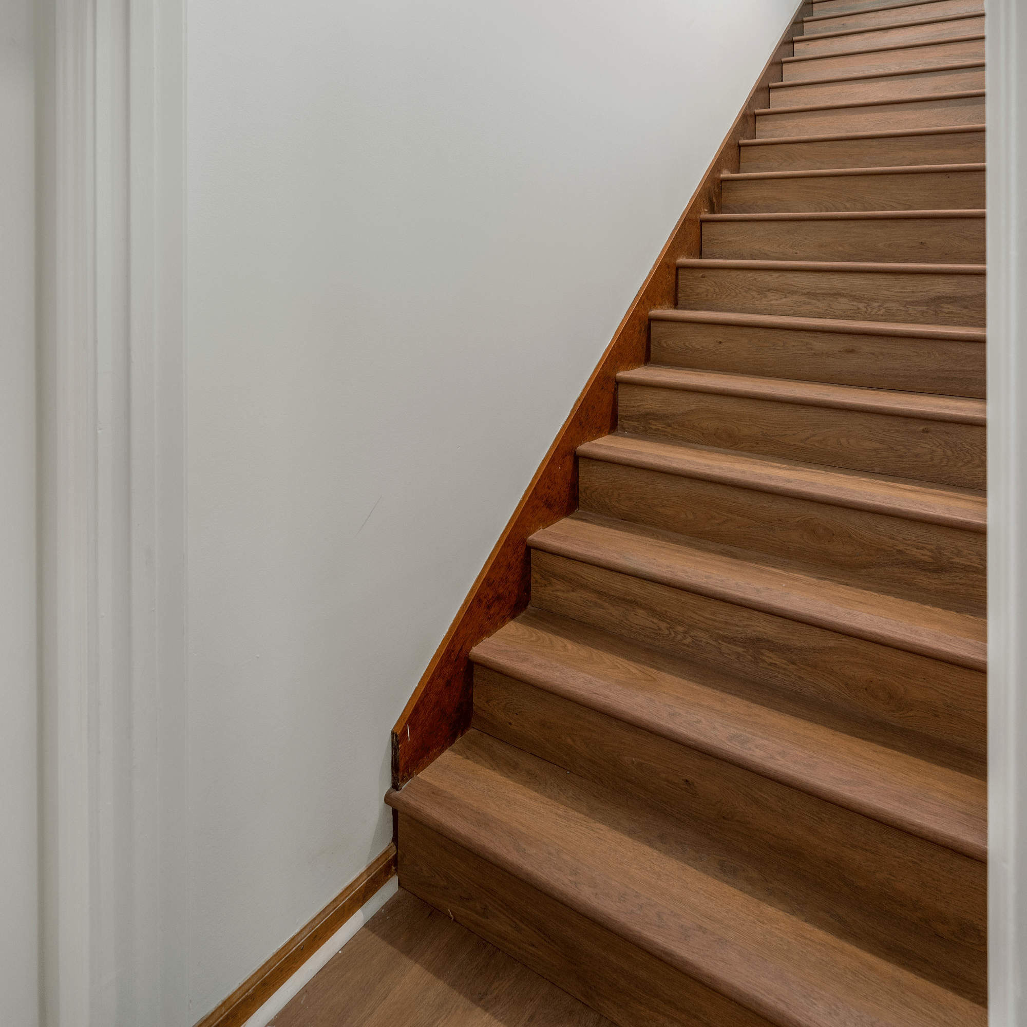 Allure Gingermisu Maple ISOCORE vinyl flooring installed in on stairs with matching looks like our overlap stairnose