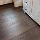 Vignette of Burnt Butter Walnut vinyl plank flooring in a bathroom