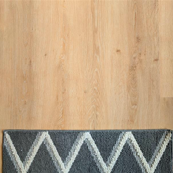 Alure honey butter oak plank flooring with a rug