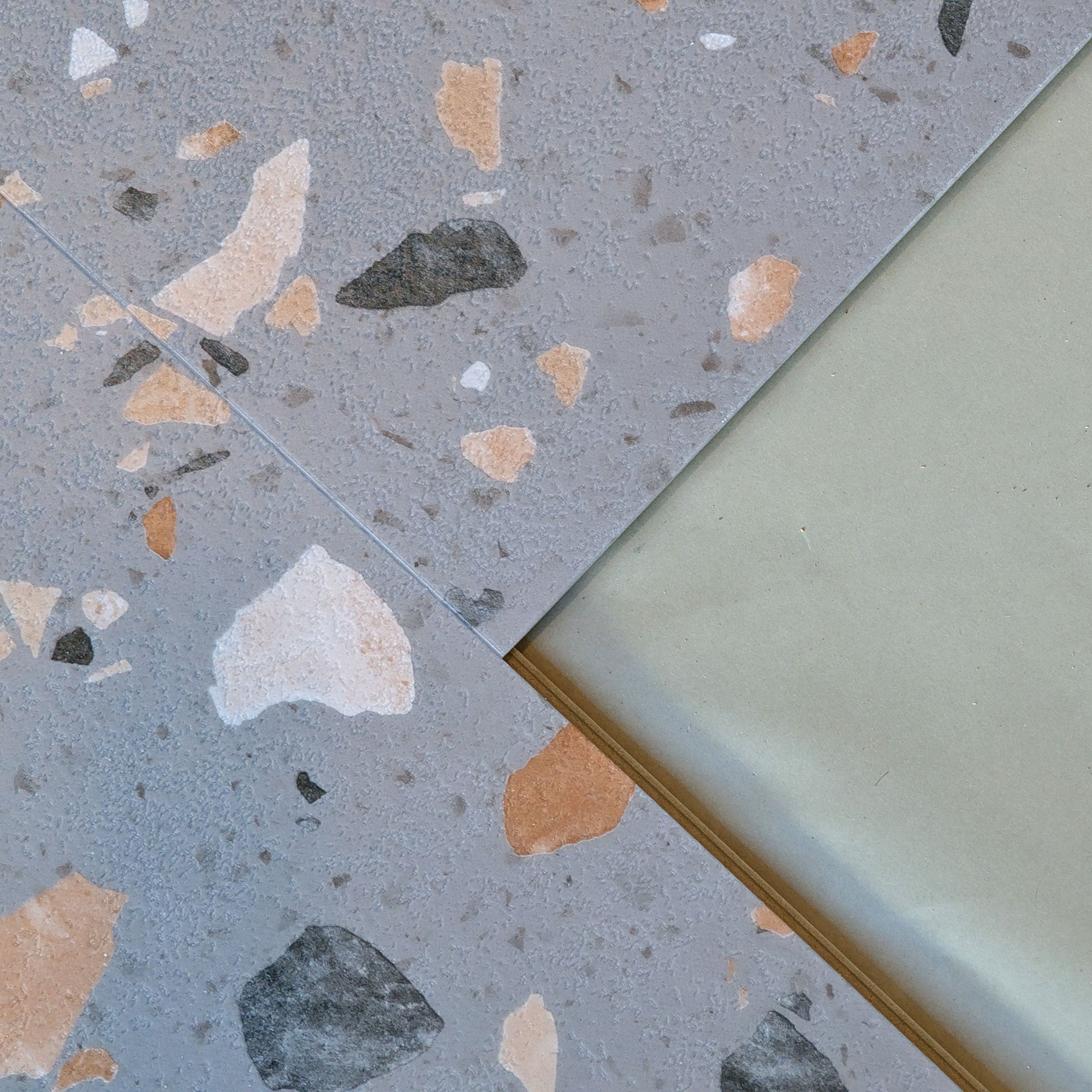 Allure Ultima Peach Pebble Terrazzo vinyl tile flooring close up view of click lock edge and microbevel