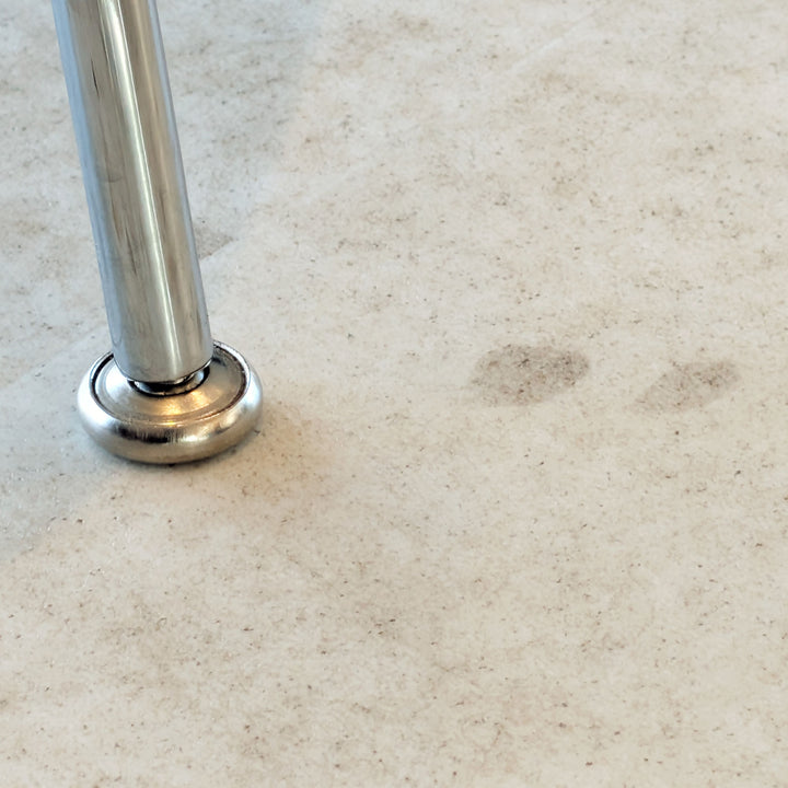 Close up of chair leg on Allure Colada Concrete terrazzo LVT flooring