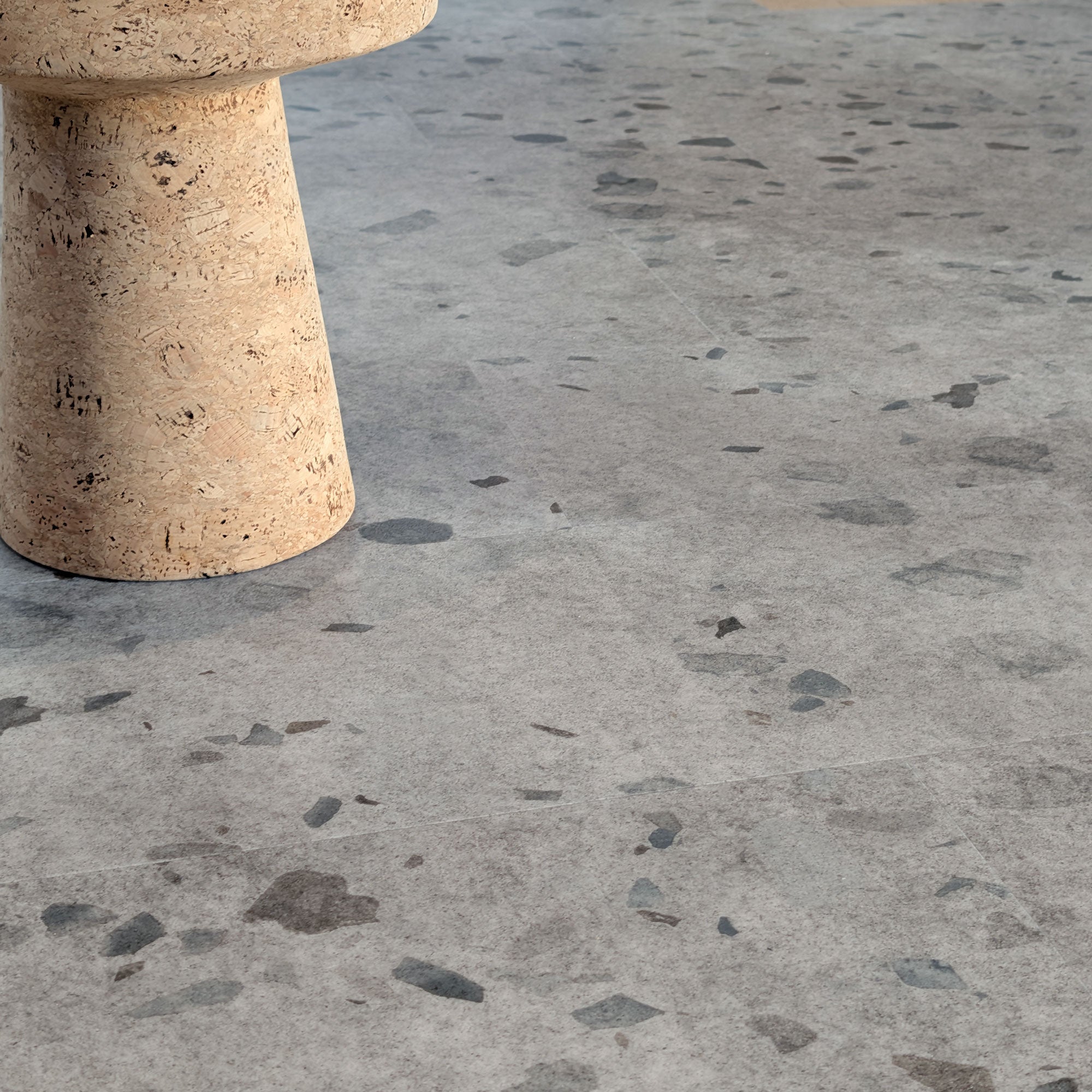 Allure Galaway Grey terrazzo vinyl tile flooring with MCM cork side table