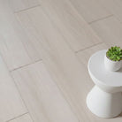 Allure pound cake pecan LVP installed with small table and plant