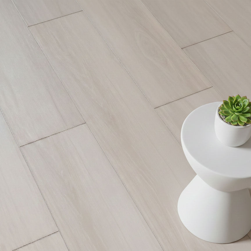 Allure pound cake pecan LVP installed with small table and plant