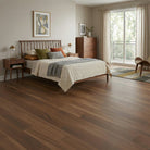 Bedroom with wooden floor, bed, and dresser near a large window.