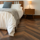Marble Cake Mahogany Chevron Flooring with mid-century bed, side table, and lamp
