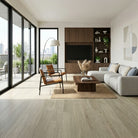 Modern living room with a large window, sofa, coffee table, and decorative items.