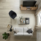Modern living room with a gray sofa, coffee table, and TV stand.