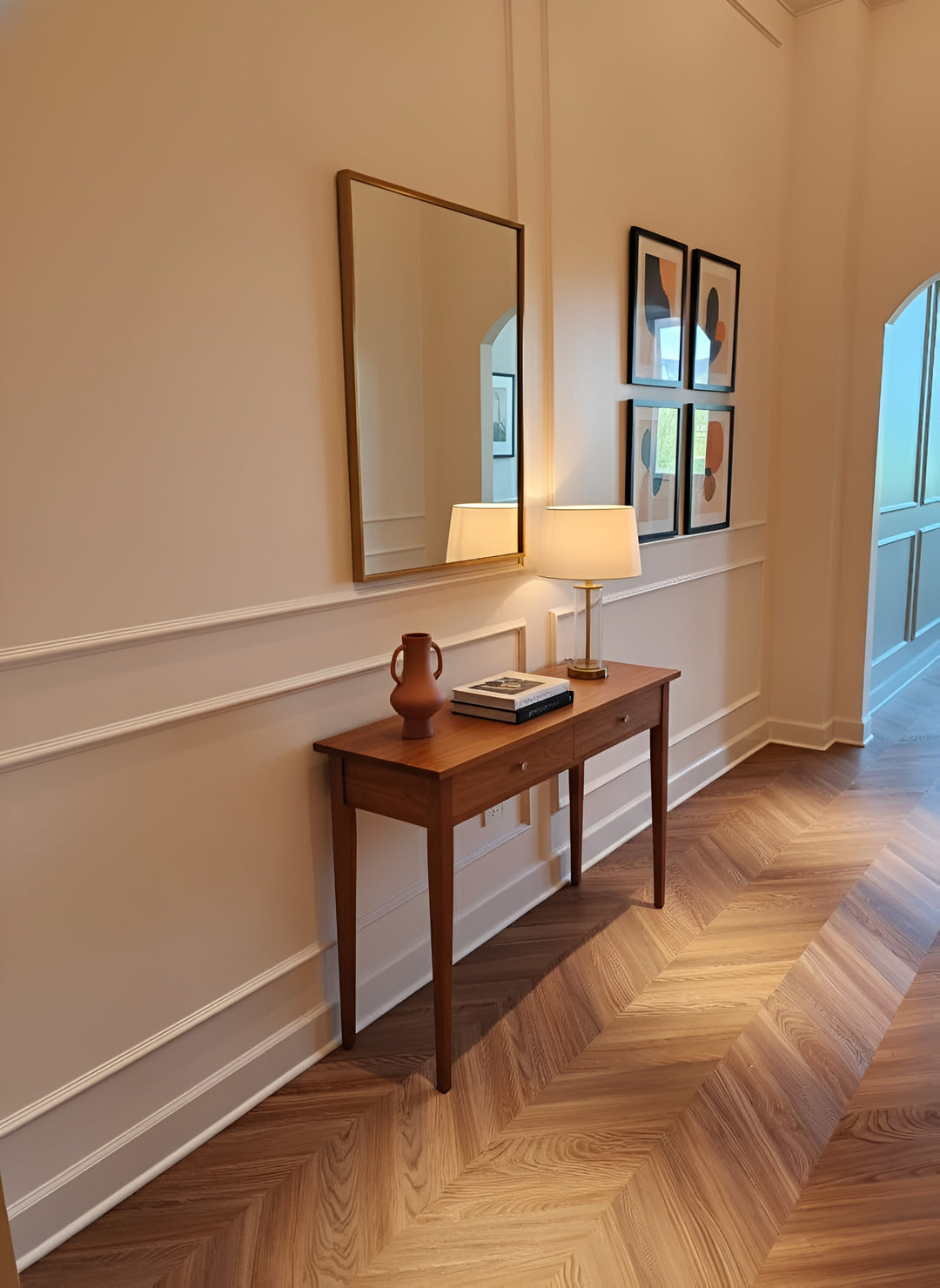 Peach Crisp Pine installed in a hallway with a wooden console table with a lamp and decorative items against a wall with a mirror and framed pictures.