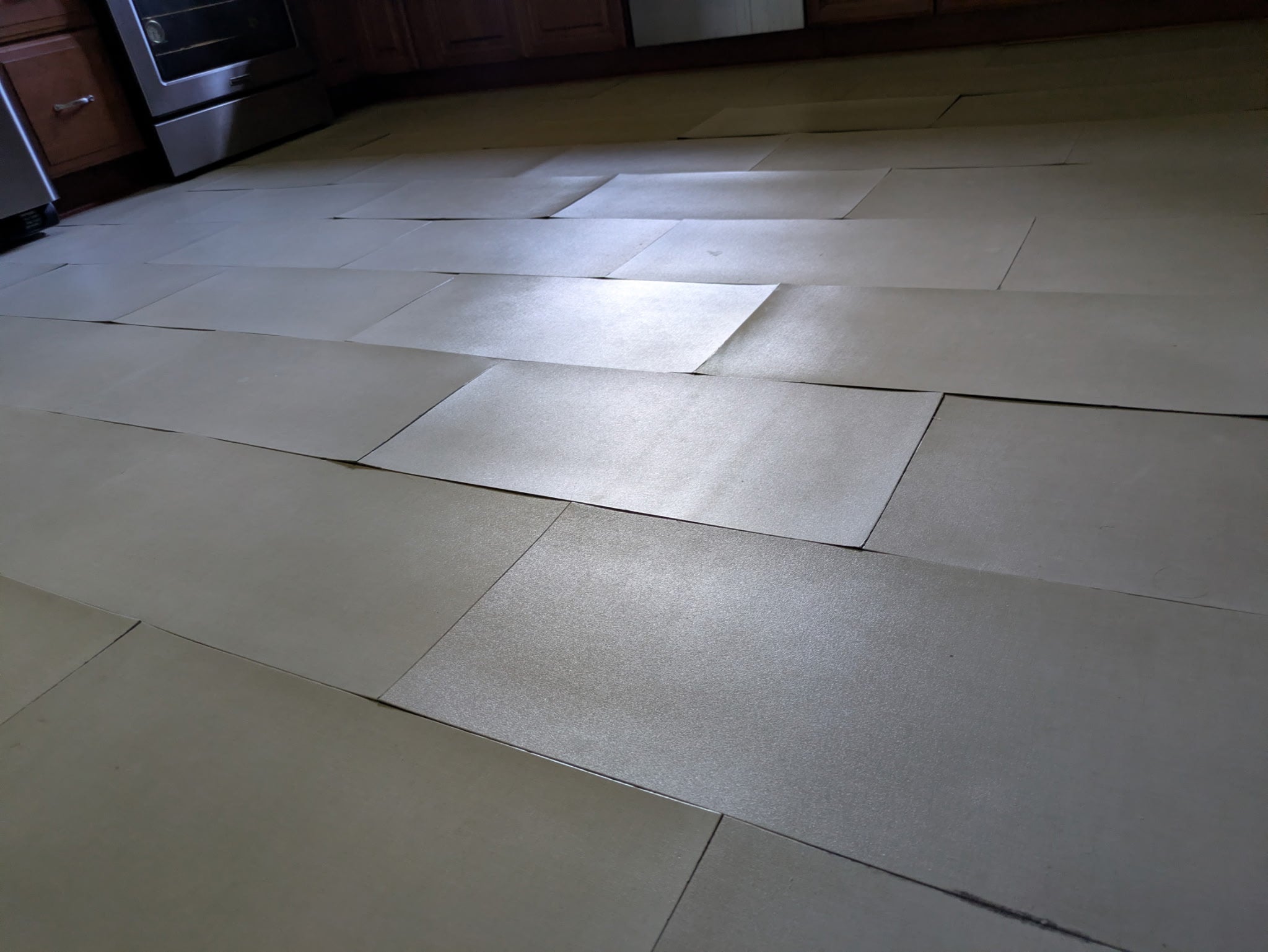 Peel and stick flooring lifting up on a kitchen